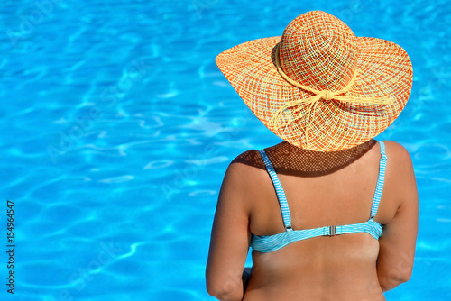 Real female beauty relaxing at swimming pool