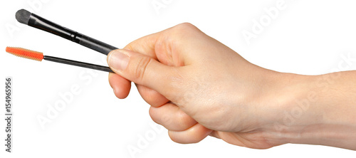 woman hand holding eyelash brush