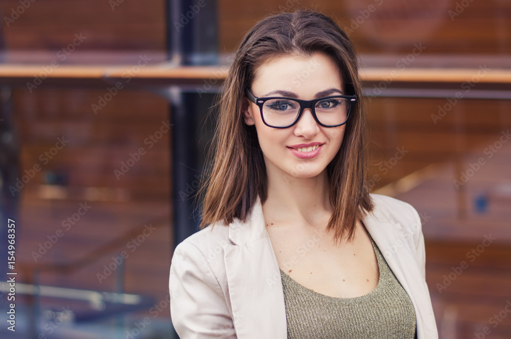 Portrait of a smiling female with short hair, eye glasses, beige jacket. Happy business woman Portrait of a smiling female with short hair, eye glasses, beige jacket. Happy business woman