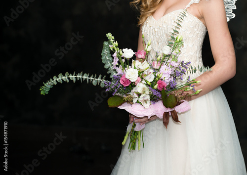 modern wedding bouquet in hands of bride copy space