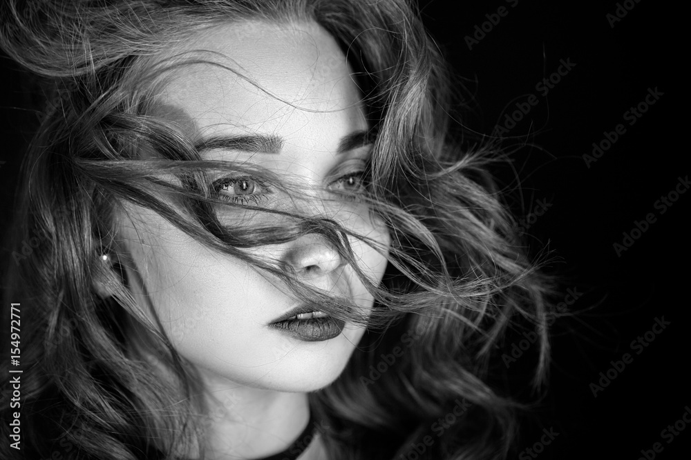 luxury woman with flying long hair on black background, monochrome luxury woman with flying long hair on black background, monochrome