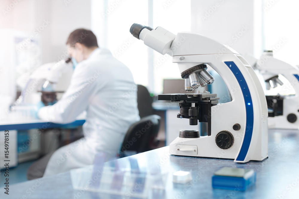 Modern microscope standing on the table Modern microscope standing on the table