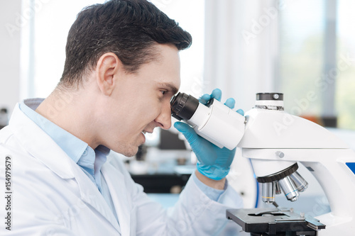 Portrait of delighted scientist while testing genetic code