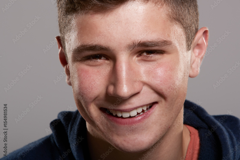 Teenage boy smiling to camera, close up Teenage boy smiling to camera, close up