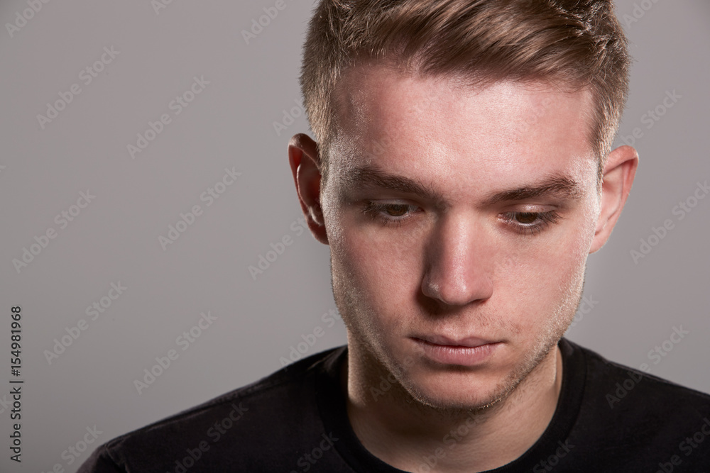 Young white man looking down, head and shoulders Young white man looking down, head and shoulders