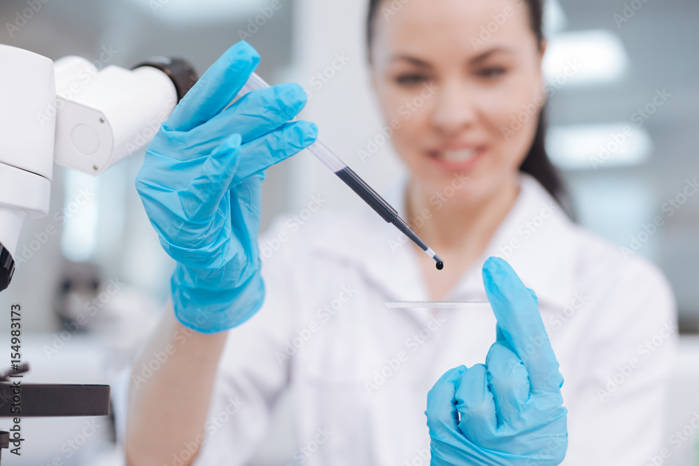 Beautiful female person researching blue liquid Beautiful female person researching blue liquid
