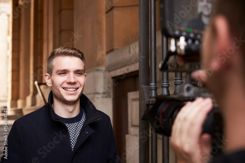 Male Television Presenter Filming Outdoor Report
