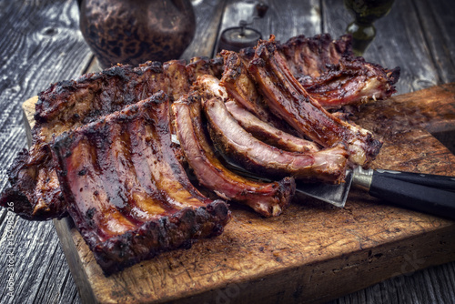 Barbecue Pork Spare Ribs as top view on an old cutting board photo