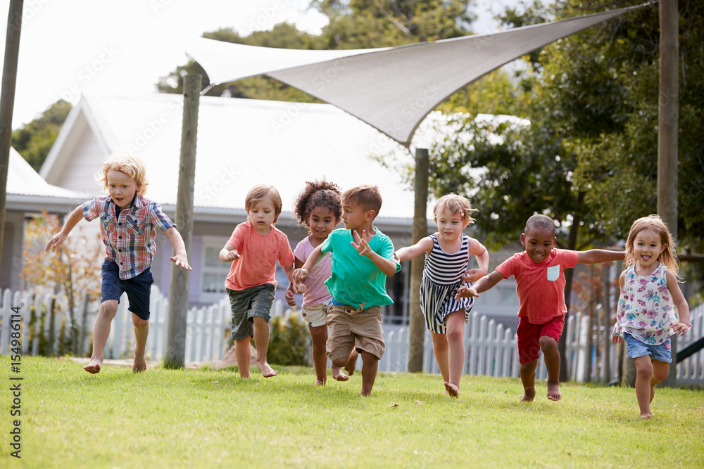 Obraz premium Children At Montessori School Having Fun Outdoors During Break