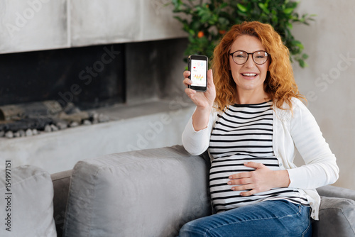 Excited prospective mom showing cellphone