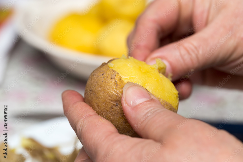 Woman cleaning potatoes with her hands Woman cleaning potatoes with her hands