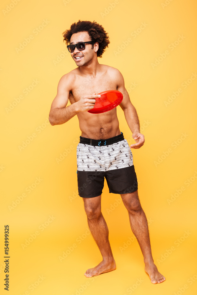 Happy young african man holding beach toy. Happy young african man holding beach toy.
