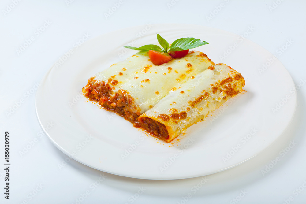 italian lasagna rolls on a white plate