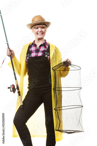 Happy woman holding fishing rod and keepnet photo