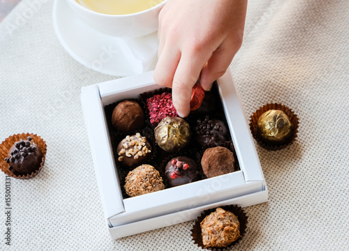 Child's hand take a sweet