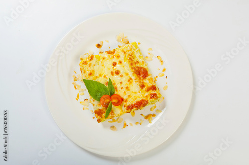 italian lasagna rolls on a white plate