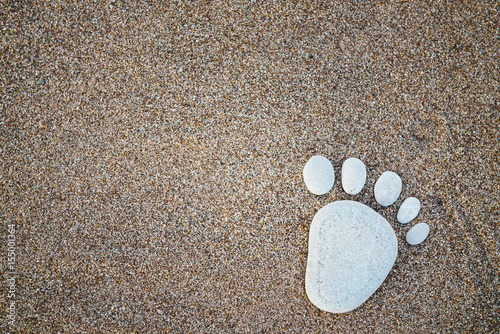 Nice stone made footprint on the sand shore, background.
