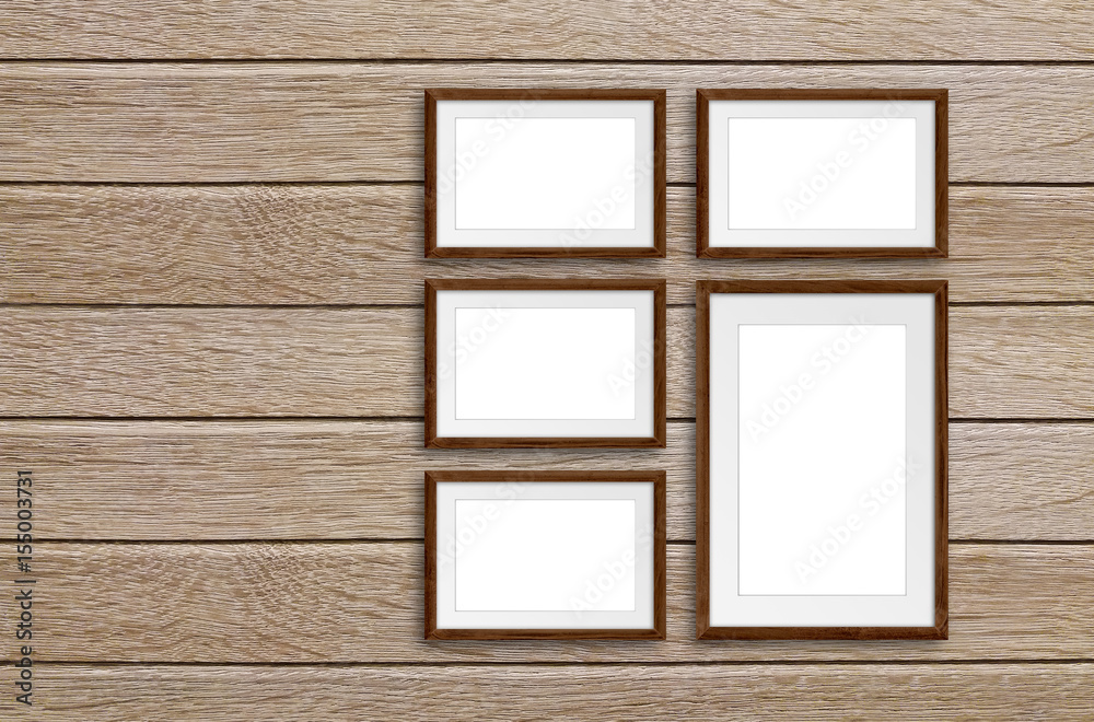 Five photo frames set on wooden panels wall, interior decor mock up Five photo frames set on wooden panels wall, interior decor mock up