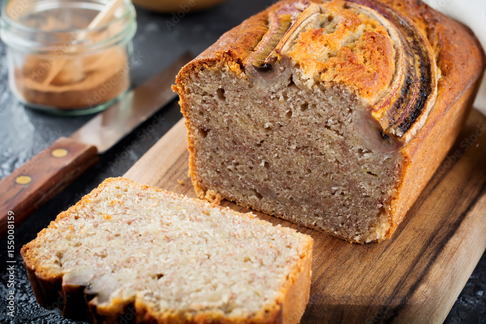 Banana bread and bananas on a dark background. Top view. Selective focus. Banana bread and bananas on a dark background. Top view. Selective focus.