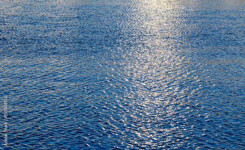 Golden moonbeam on calm blue ocean
