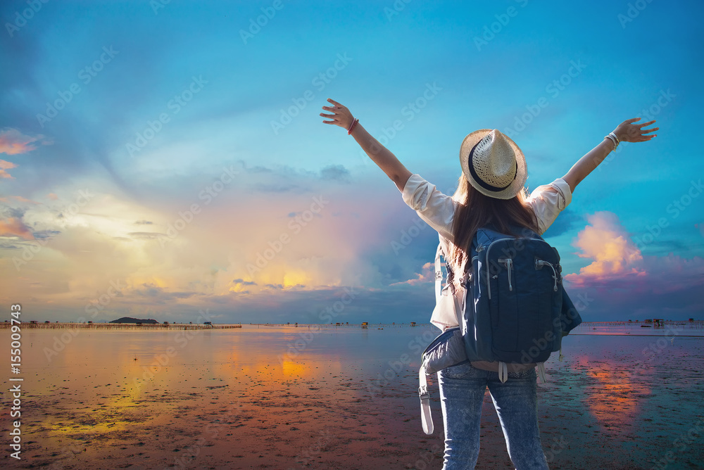 Freedom traveler girl standing with raised arms and enjoying a beautiful nature. Freedom traveler girl standing with raised arms and enjoying a beautiful nature.
