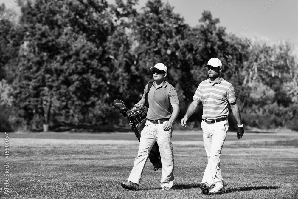 Golfer and caddy on golf course