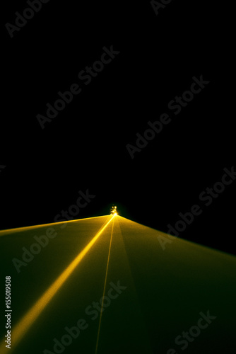 Laser beam tilt orange on a black background