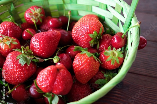 Basket with fresh strawberries and cherries  