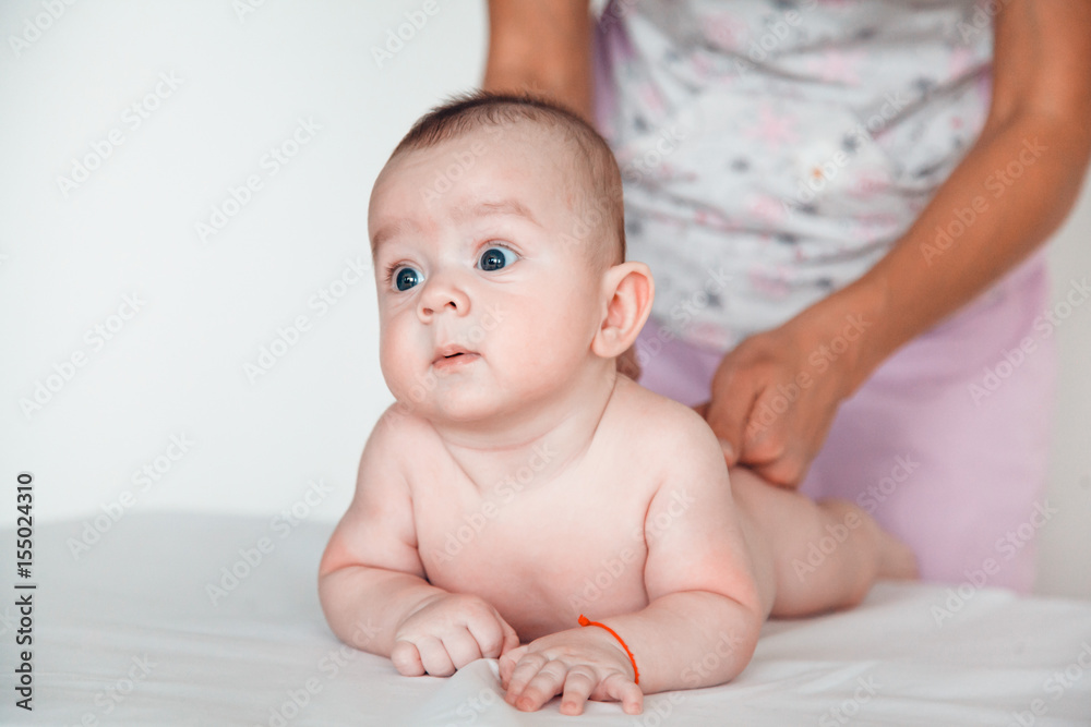 Woman doctor doing back massage to baby. Children's massage. Woman doctor doing back massage to baby. Children's massage.