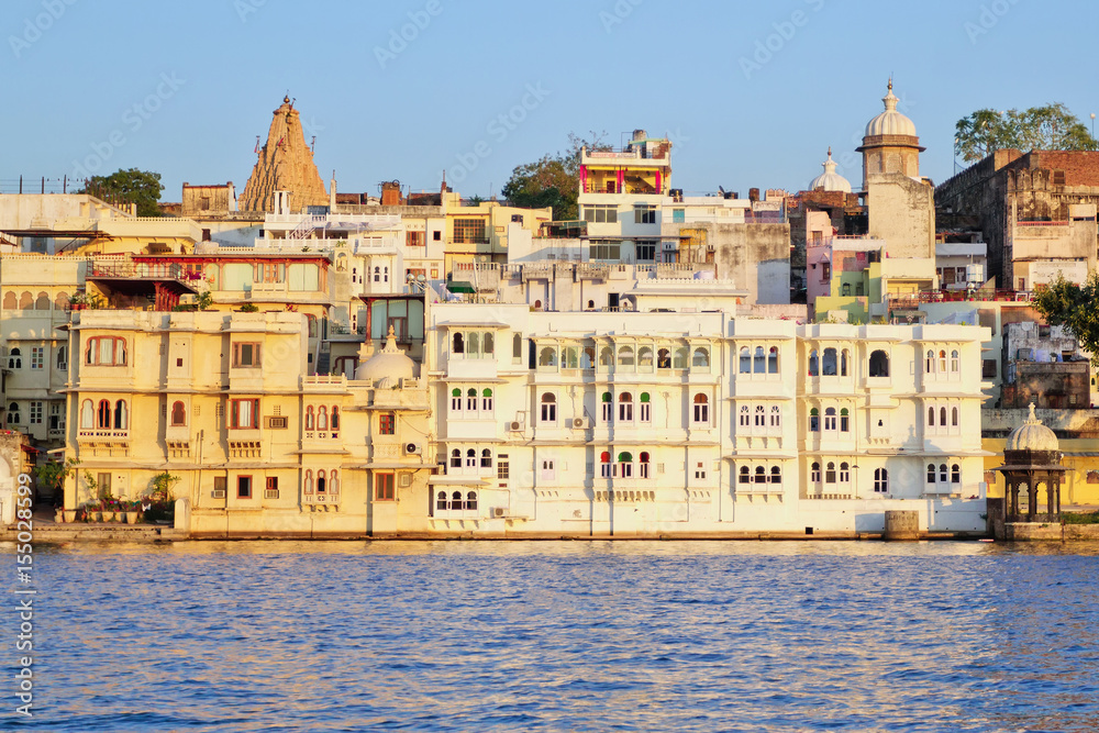 Udaipur historical buildings against blue sky in Rajastan, India. View from Pichola Lake