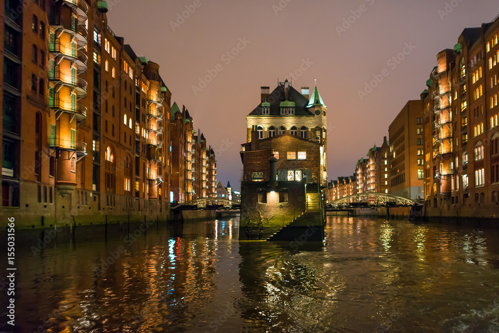 The illuminated and famous ware house district Speicherstadt in Hamburg at night on November. To see, the Water castle