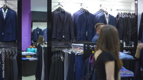 Wallpaper Mural Young couple choose a jacket in the store. Loving guy and girl buy clothes in the store Torontodigital.ca