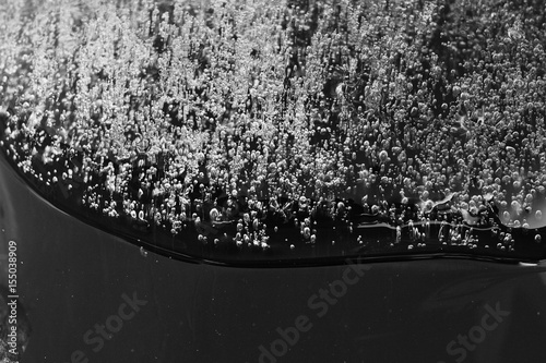 Frozen gas bubbles settle on the air cavity in the ice. A beautiful natural phenomenon. Greenhouse effect. Colorful blue cool colors. Abstract background. Frozen, unique ice bubbles.. photo