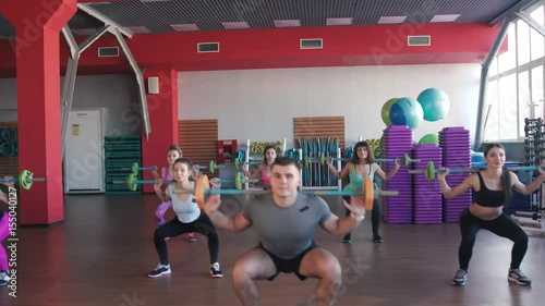 Fitness, sport, training - group of women and man with barbells in gym