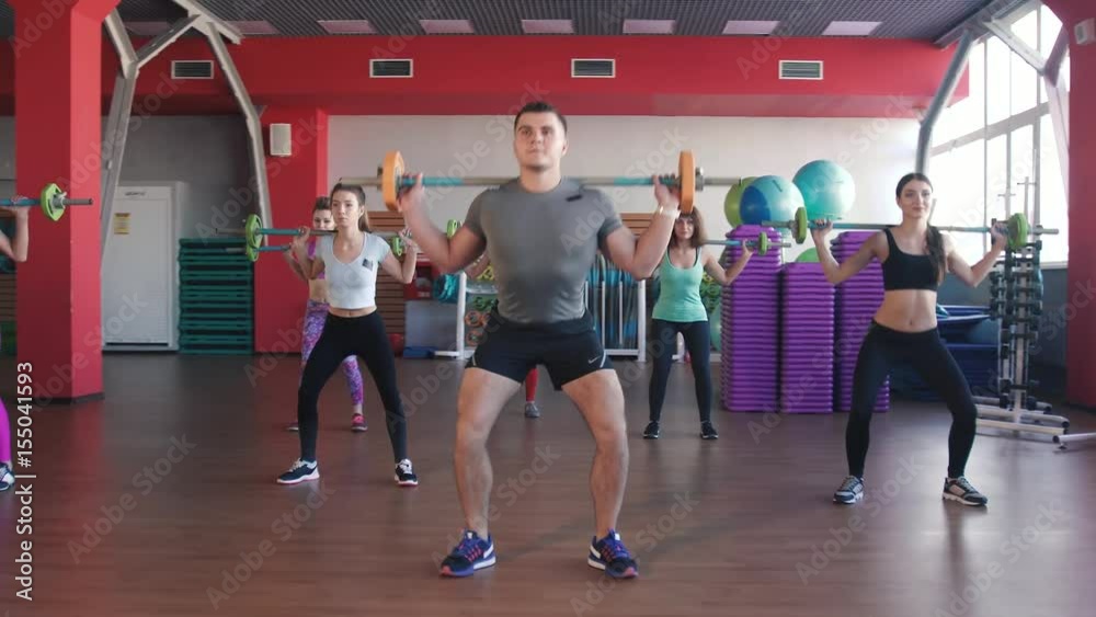 Fitness, sport, training - group of women and man with barbells in gym