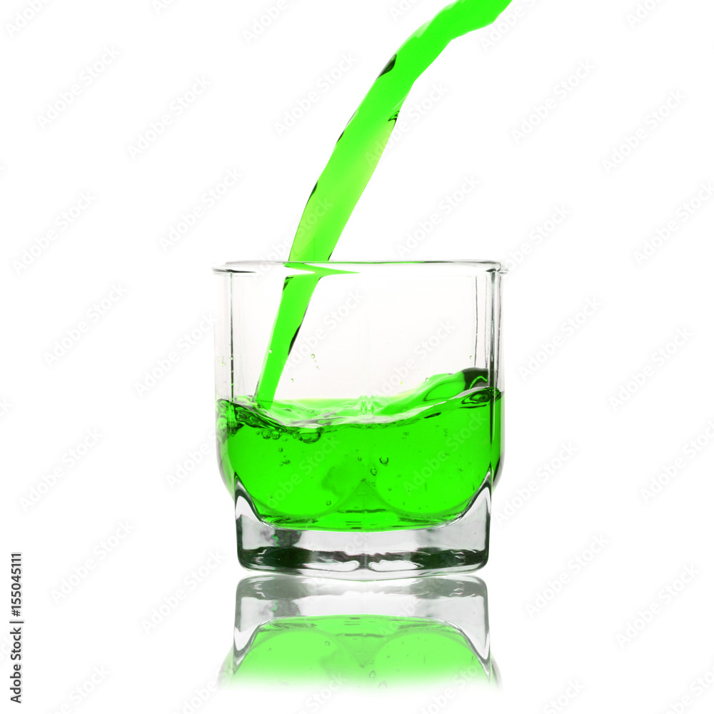 green cocktail splashing on a glass on white background green cocktail splashing on a glass on white background