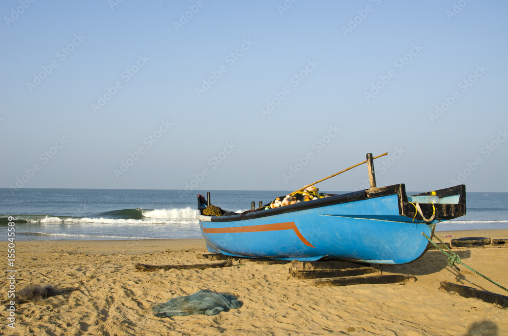 Fishing boat on sea coast beach in Karnataka, India