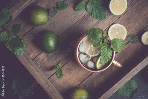 Photography Cold Moscow Mule cocktail in copper mug on the rustic background