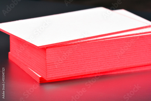 thick white cotton paper business card mock up with red painted edges. Blank business cards template.