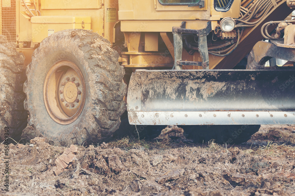 Grader leveling landfill on construction site before kick off project
