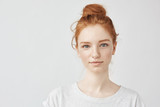 Portrait of beautiful redhead girl smiling looking at camera.