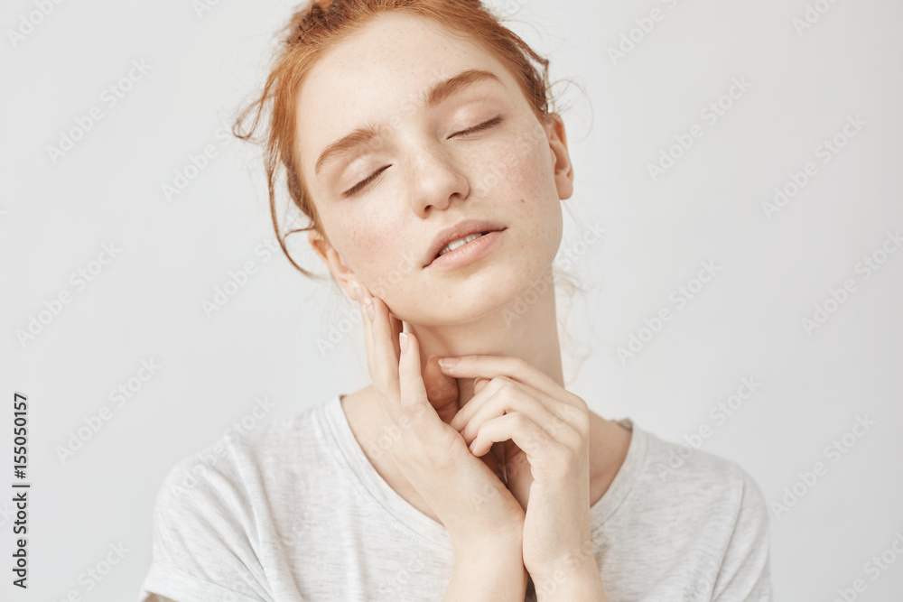 Portrait of tender girl with foxy hair and closed eyes smiling. Portrait of tender girl with foxy hair and closed eyes smiling.