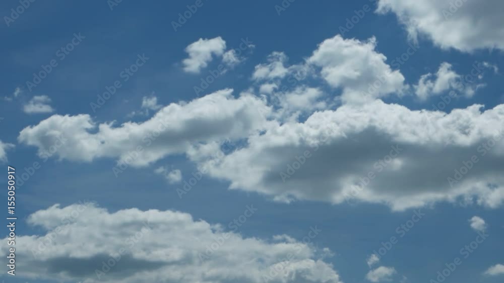 White clouds run against the blue spring sky White clouds run against the blue spring sky