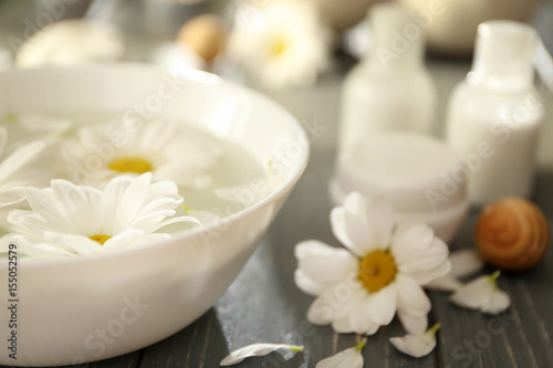 Beautiful spa composition of flowers in bowl with water on table