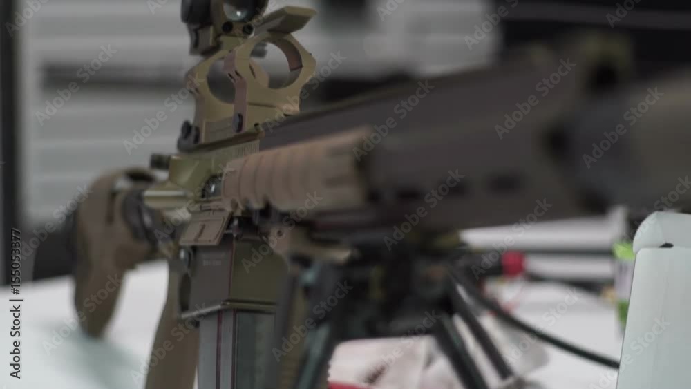 Sniper rifle with an optical sight stands on sacks. Military camouflage rifle Sniper rifle with an optical sight stands on sacks. Military camouflage rifle