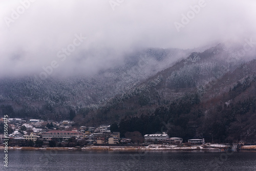 Mountain in low lying cloud and snow with the village shrouded in mist a scenic landscape view at Japan. travel Winter landscape in japan. © ordinary042