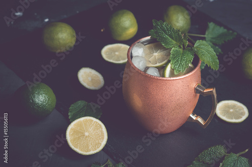 Photography Cold Moscow Mule cocktail in copper mug on the rustic background