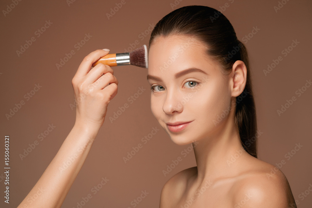 Fototapeta premium Beautiful female eyes with make-up and brush
