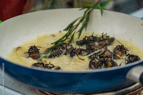 Cooking cockroaches on butter with herbs