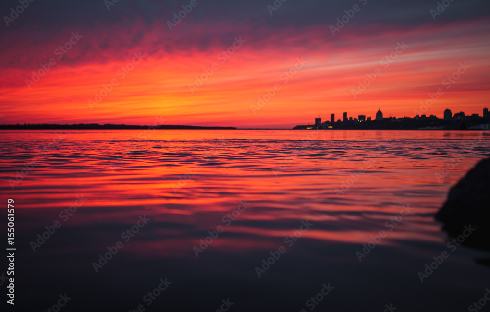 Magnificent pink sunset over the urban landscape and the river beautiful background